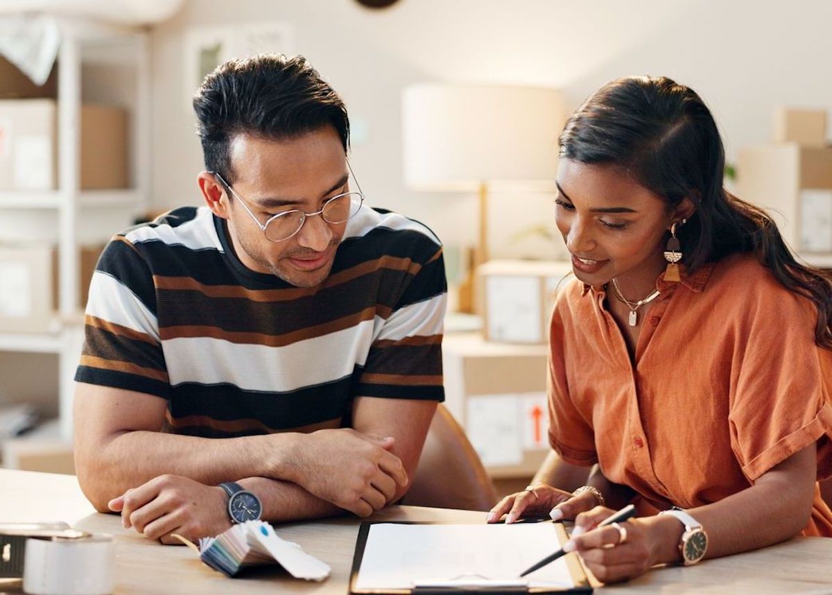 Training, employee and woman in small business with logistics, checklist or planning a schedule in office. Working, strategy and people check inventory, paperwork or reading rules of workplace Design and Planning